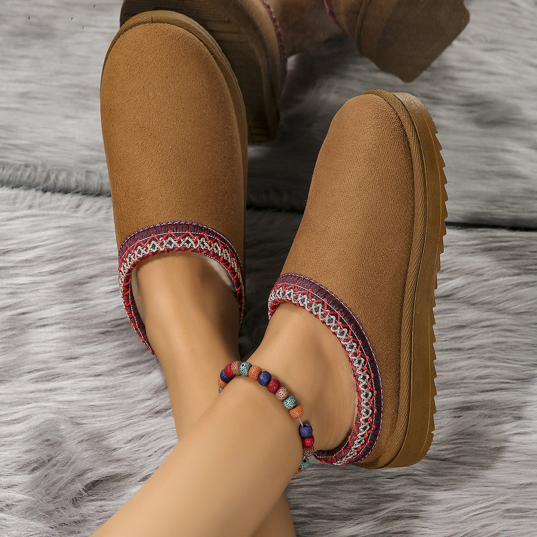 Maroon slipper side view showing the textured rubber sole and patterned trim