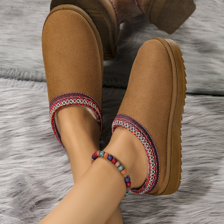Maroon slipper side view showing the textured rubber sole and patterned trim